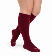 Cranberry knee-high bamboo compression socks shown on the legs.