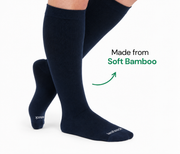 Navy knee-high bamboo compression socks shown on the legs from an angled side view.