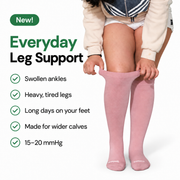 Woman adjusting pink knee-high bamboo wide-calf compression socks.